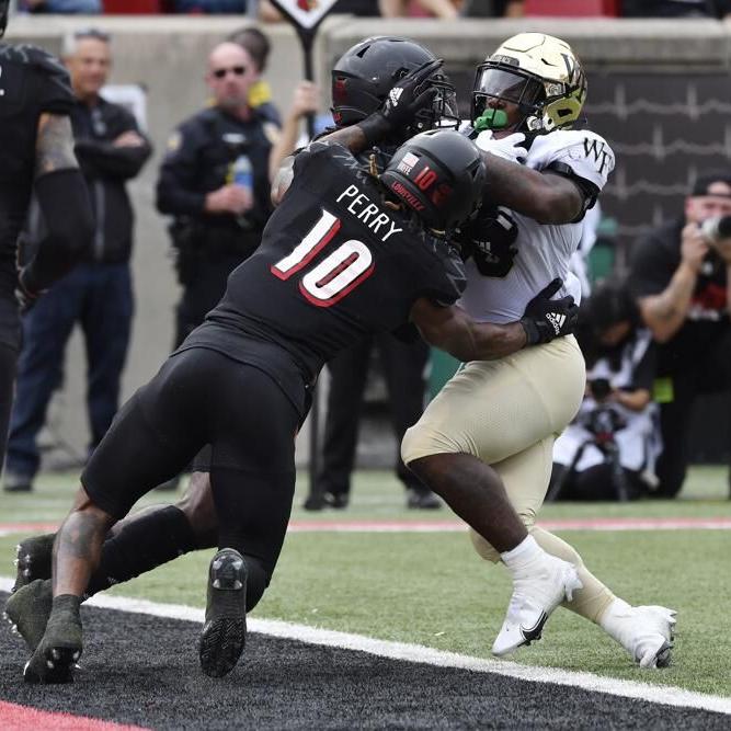 Wake Forest running back Justice Ellison is pushed back from.jpeg